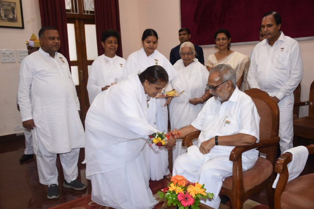 Brahma Kumaris tying Rakhi to His Excellency Governor Proff Ganeshi Lal...